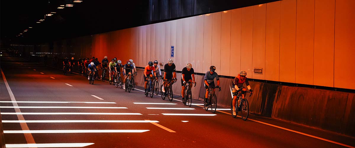 Group of cyclists riding in a tunnel